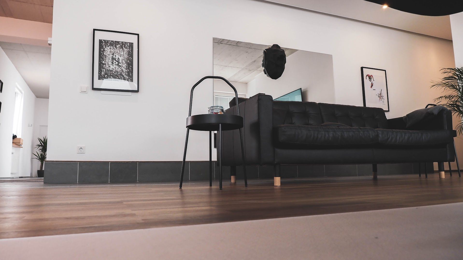 a black couch sitting in a living room