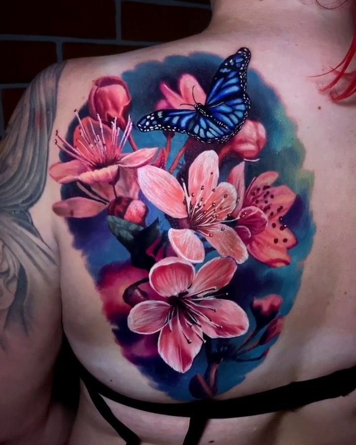 a woman with a butterfly on her chest