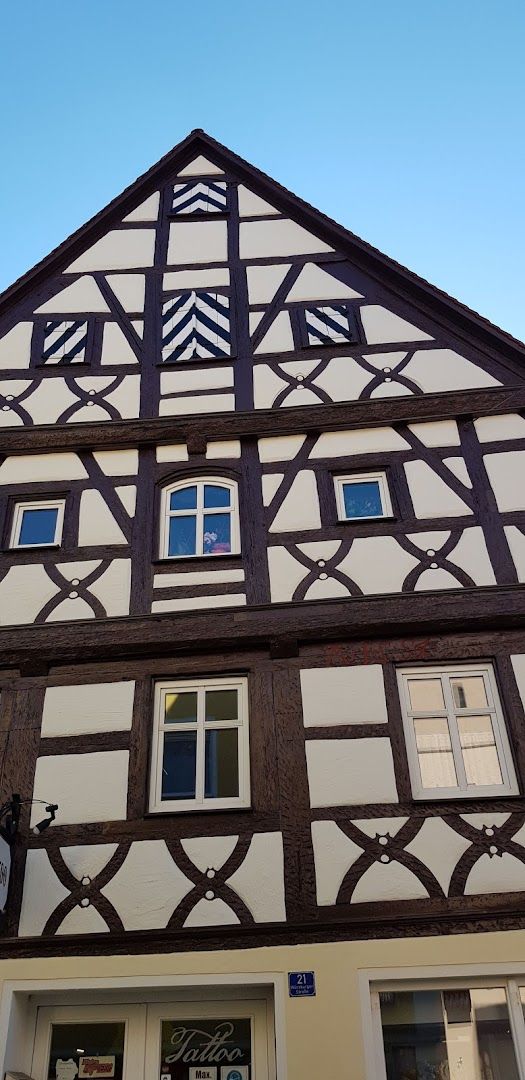 a building with a large wooden window and a white and black building