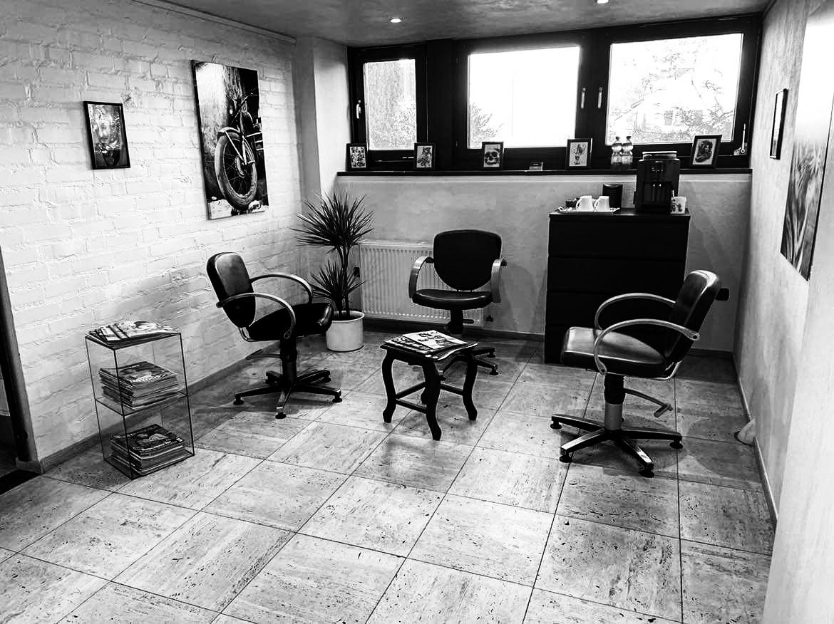 a black and white photo of a room with chairs