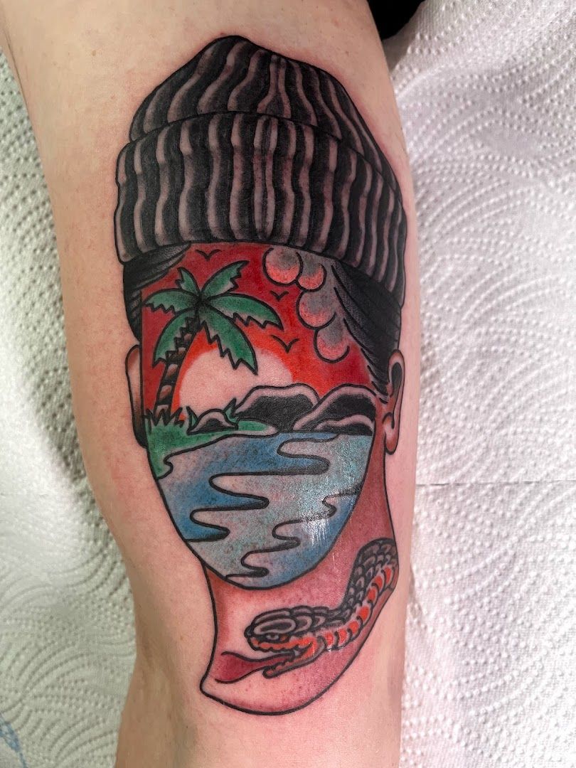 a narben tattoo of a woman with a hat and a palm tree, berlin, germany