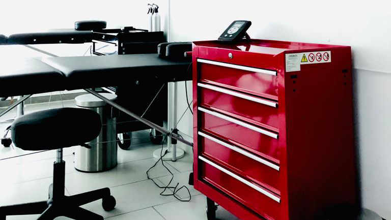 a red tool cabinet sitting next to a computer