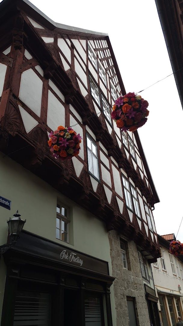 a building with flowers hanging from the side