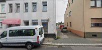 a white van parked in front of a building