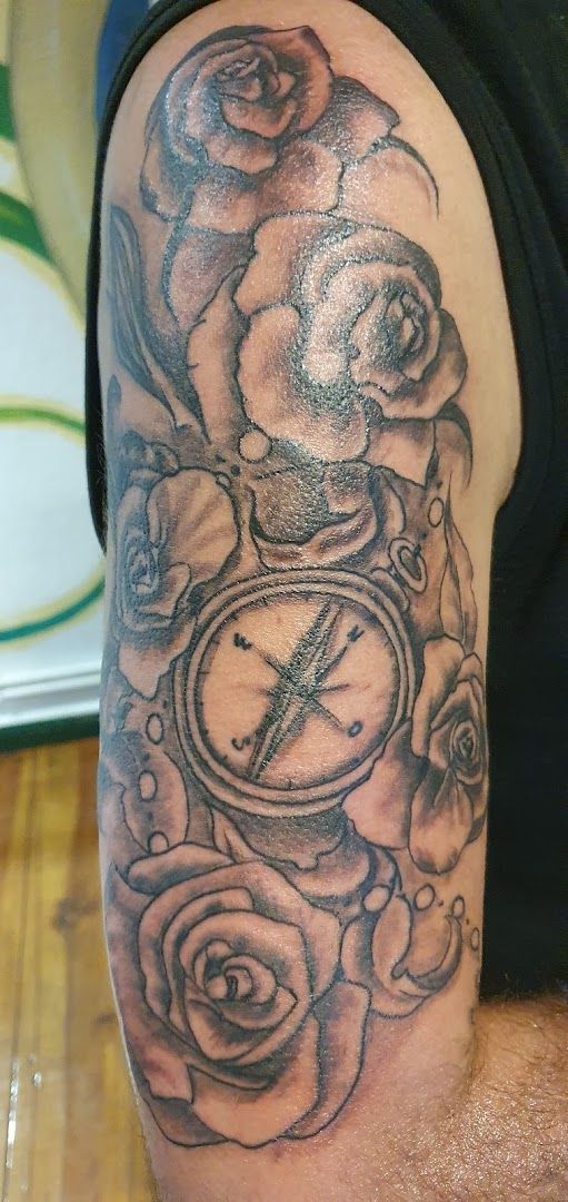 a man with a clock and roses on his arm