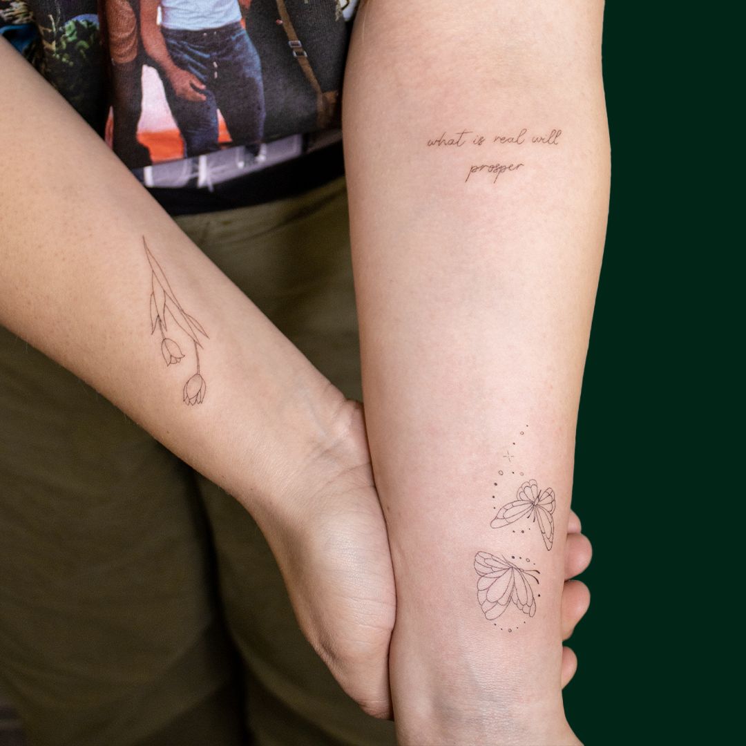 a woman holding a small narben tattoo on her arm, berlin, germany