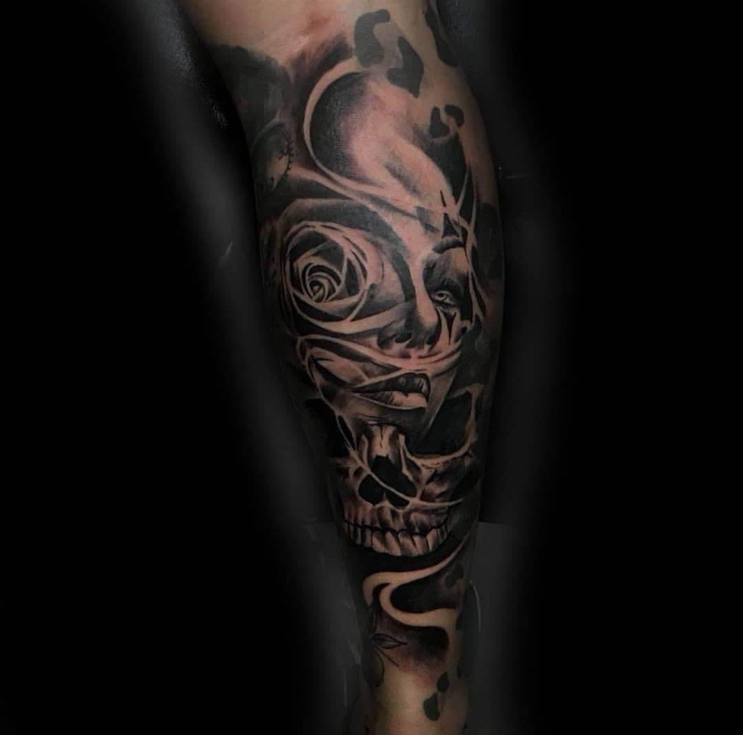 a skull with roses on it's leg