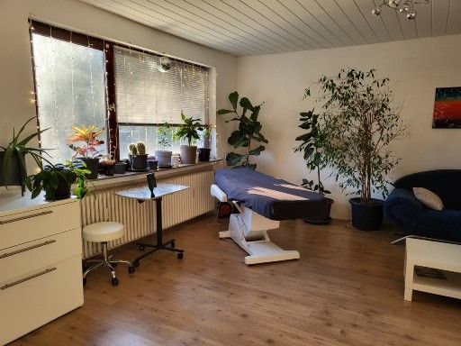 a room with a couch, desk and chair