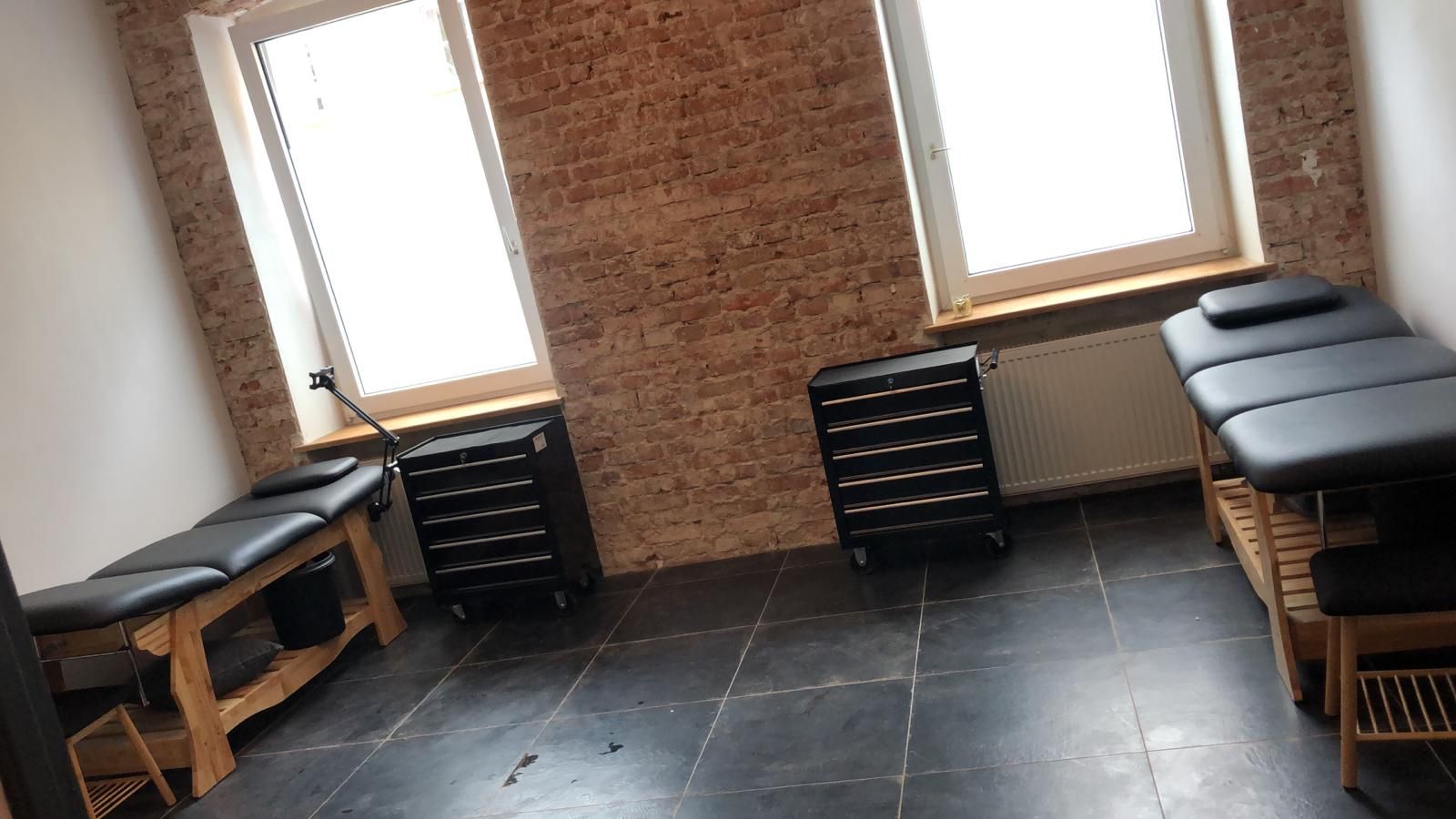 a room with a brick wall and a black table