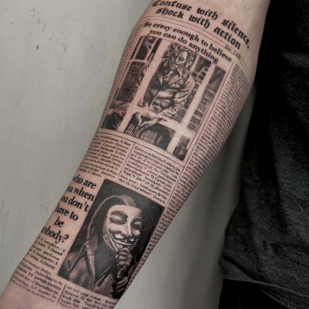 a man's arm with a newspaper page and a black and white photo