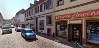 a street with cars parked in front of buildings