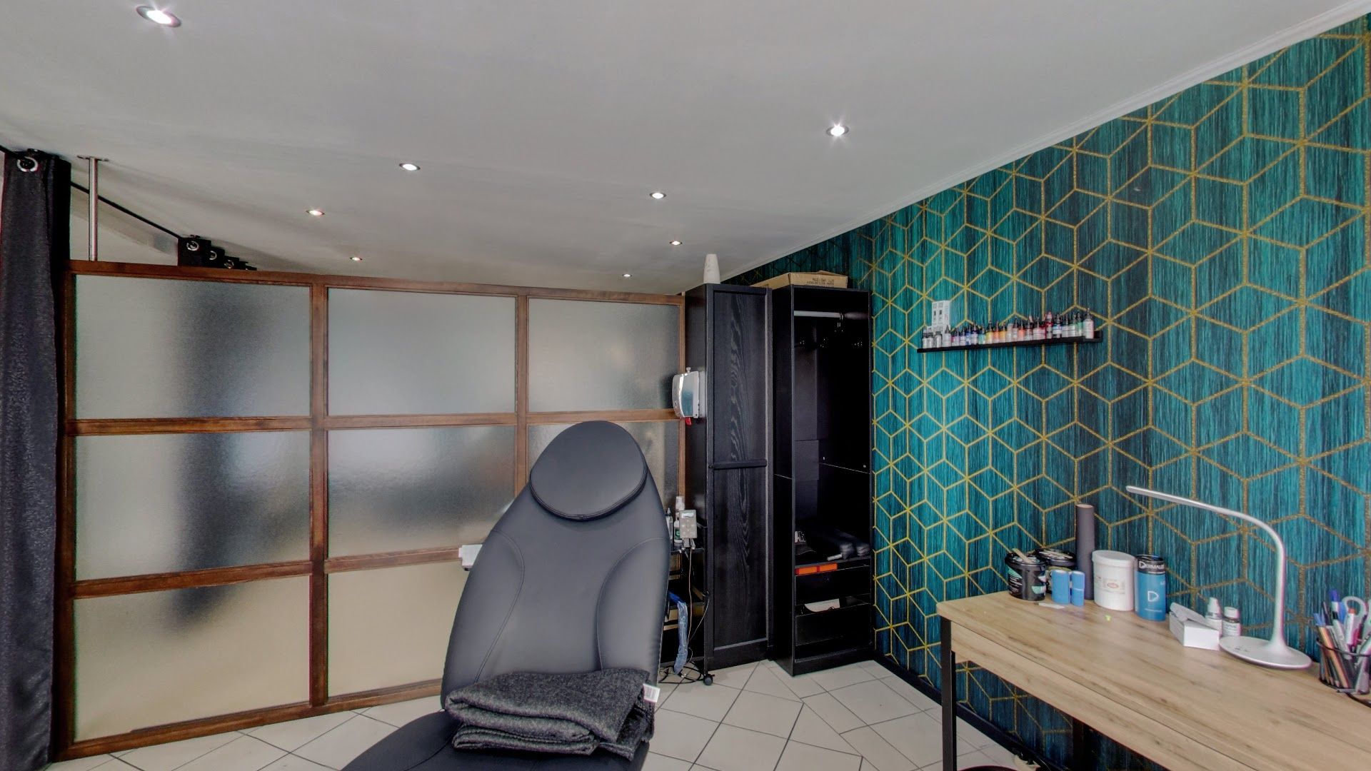 a room with a desk, chair and a wallpaper