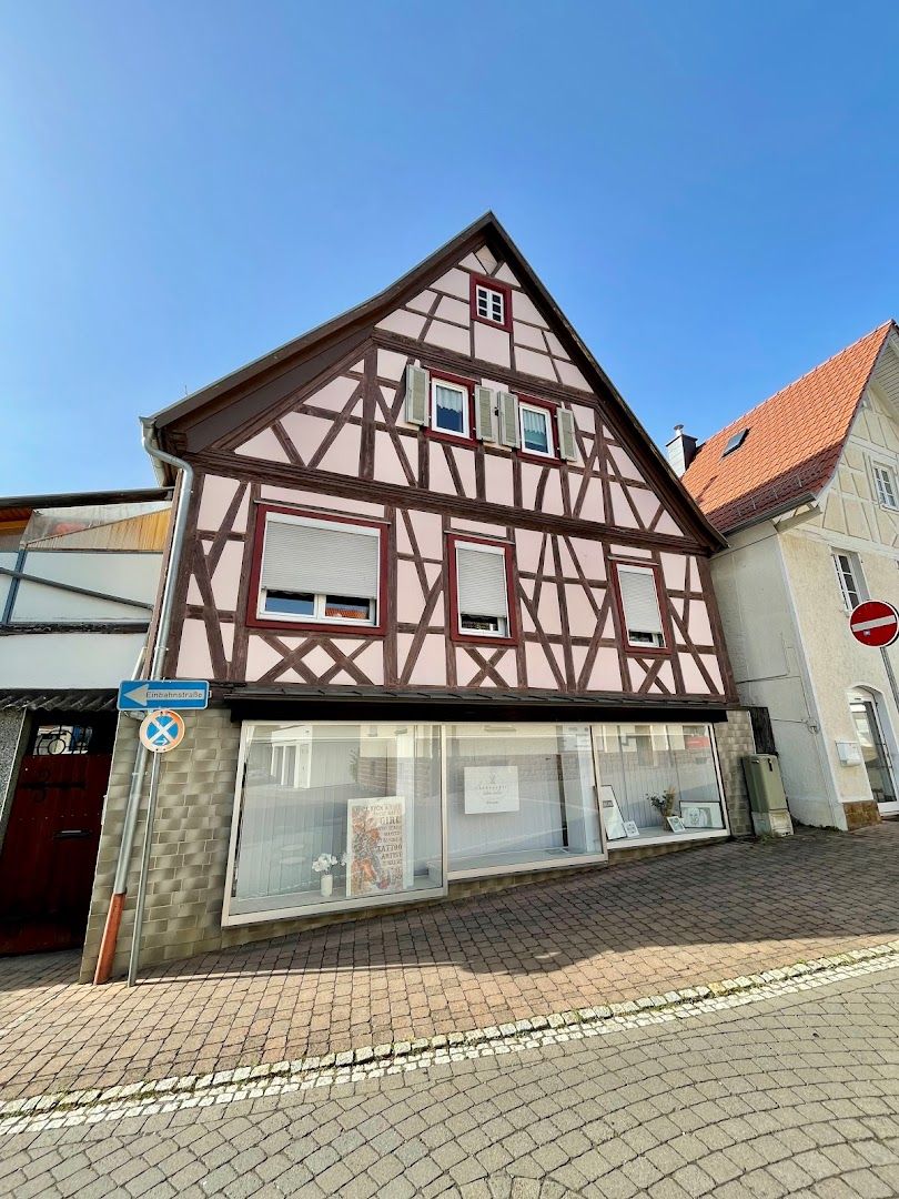 a house with a red and white facade