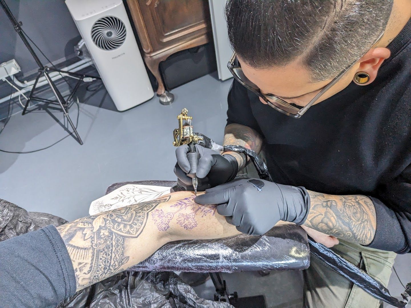 a man getting his blackwork tattoo done, berlin, germany