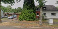 a street view of a house with a tree in the fore