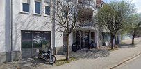 a street with a building and a bike parked on the side
