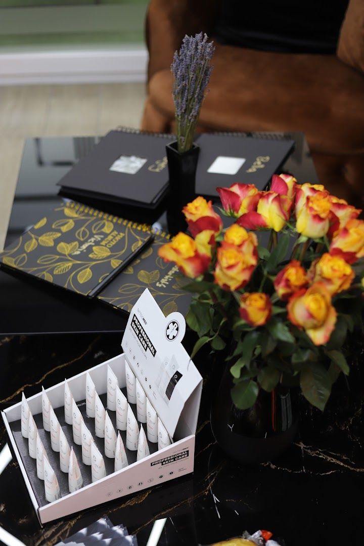 a table with a vase and a box of candles