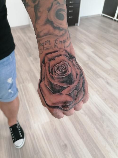 a man's hand with a cover-up tattoo on it, paderborn, germany