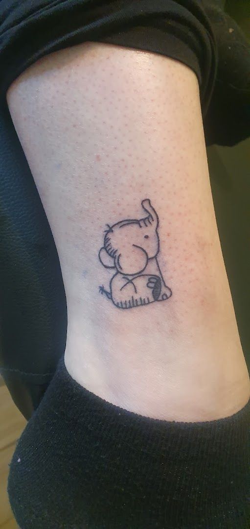 a small narben tattoo of a dog on the ankle, enzkreis, germany