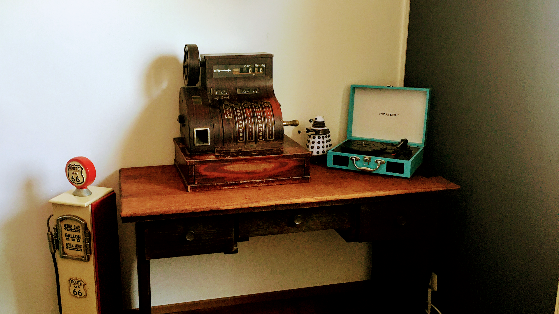 a desk with a typewriter and a phone