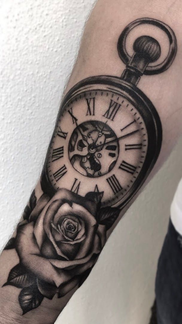 a clock and rose narben tattoo on the forearm, biberach, germany