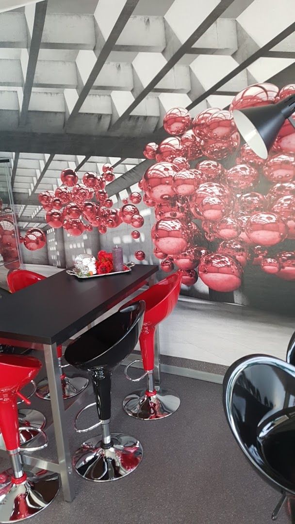 a room with a table and chairs and a large mural