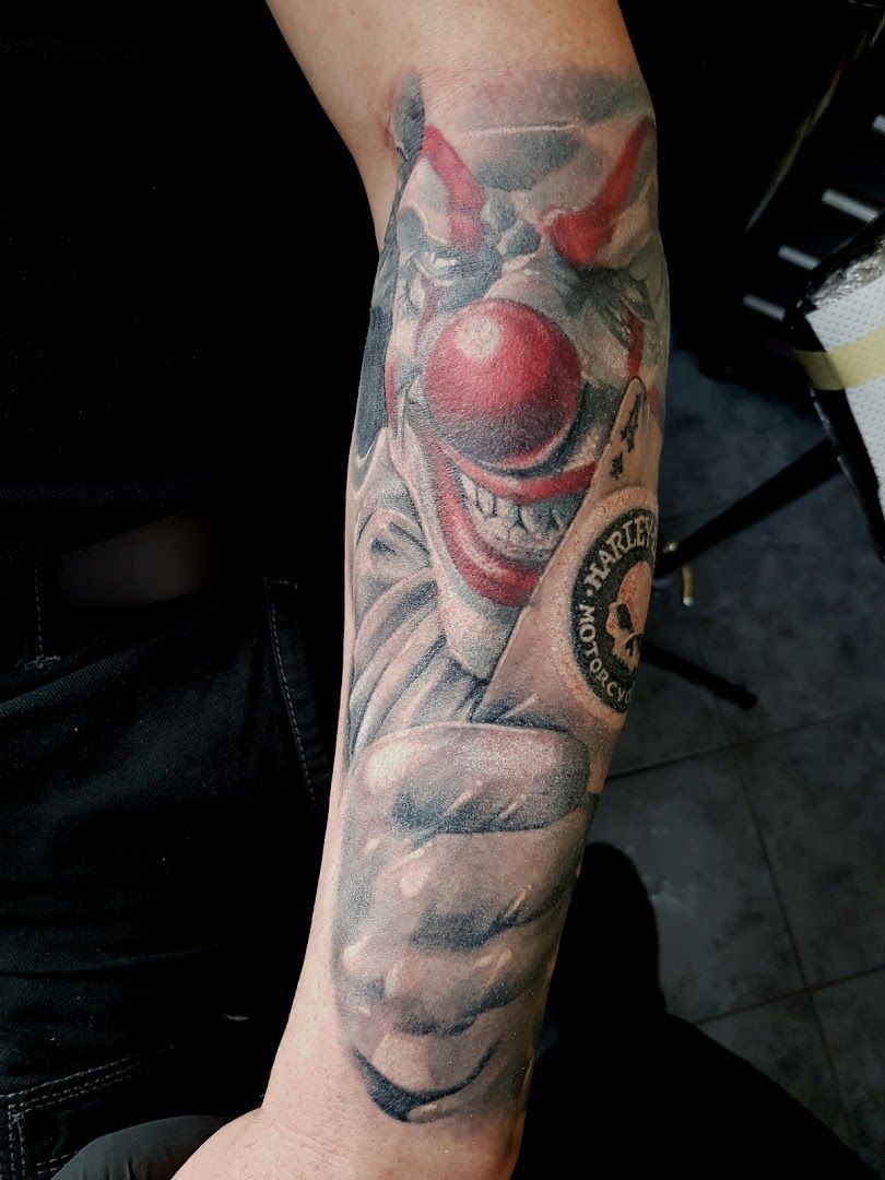 a clown cover-up tattoo on the arm, frankfurt, germany