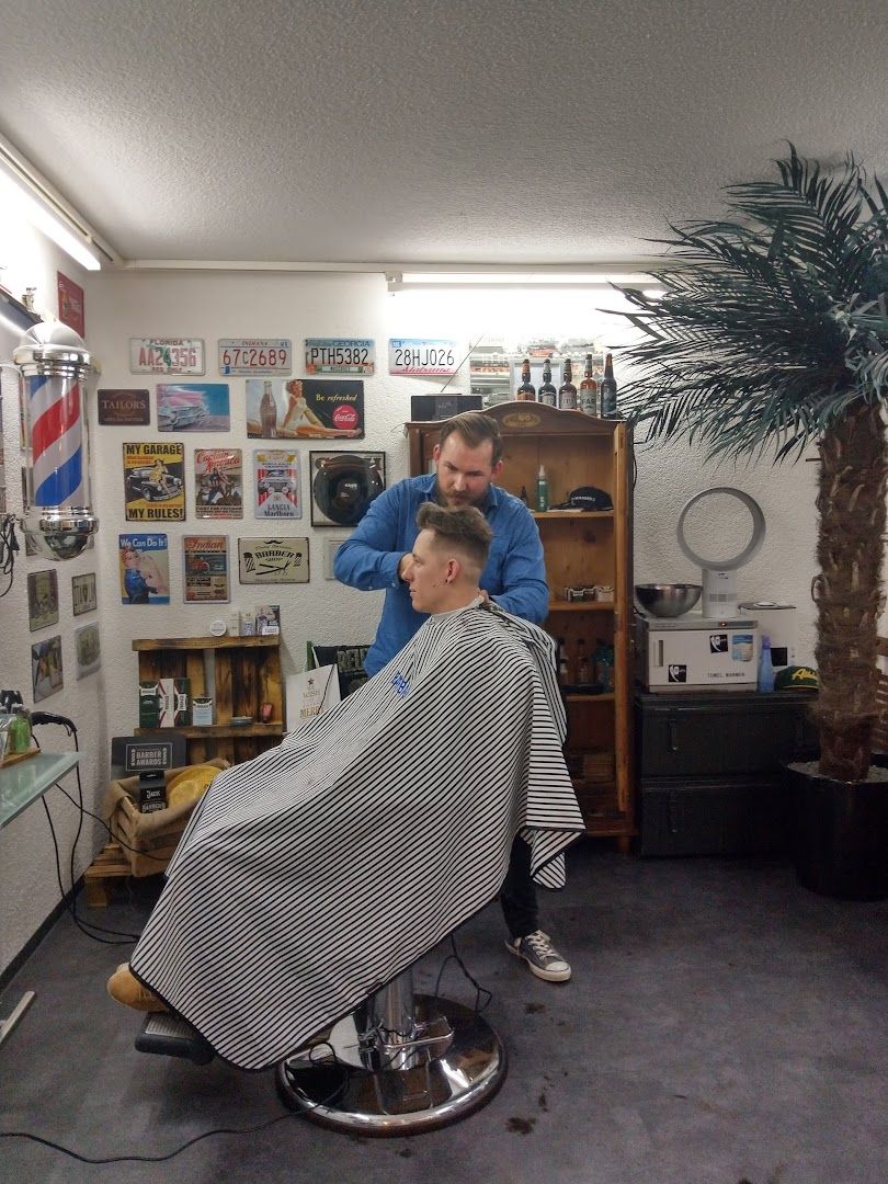 a man getting his hair cut in a barber