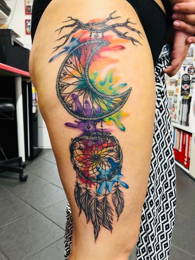 a colorful cover-up tattoo design on the thigh, schwerin, germany