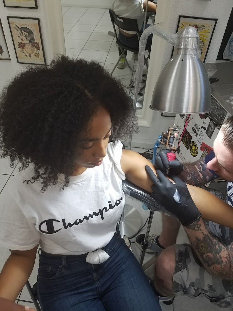 a woman getting her hair done by a barber