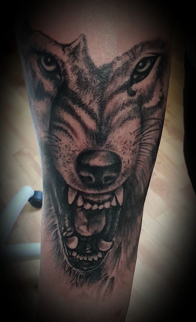 a wolf cover-up tattoo on the leg, uckermark, germany