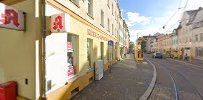 a street with a yellow building and a red fire hydra