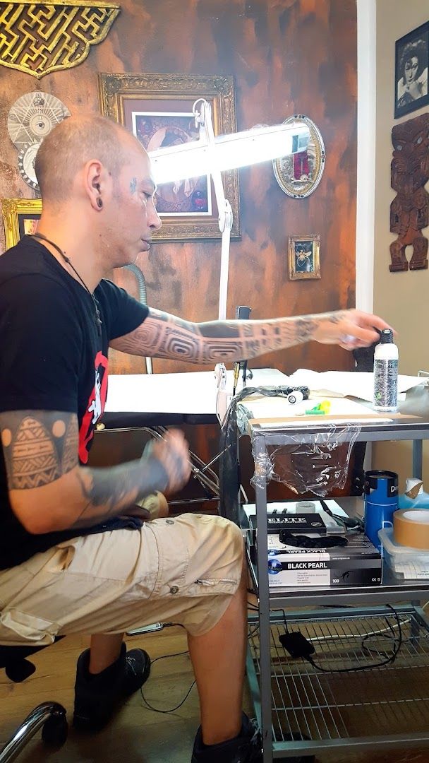 a man sitting in front of a table with a laptop