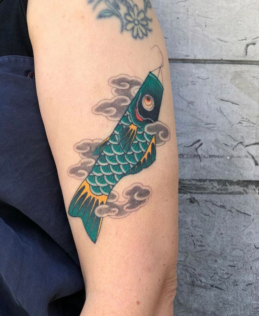 a cover-up tattoo of a koi fish on the arm, frankfurt, germany