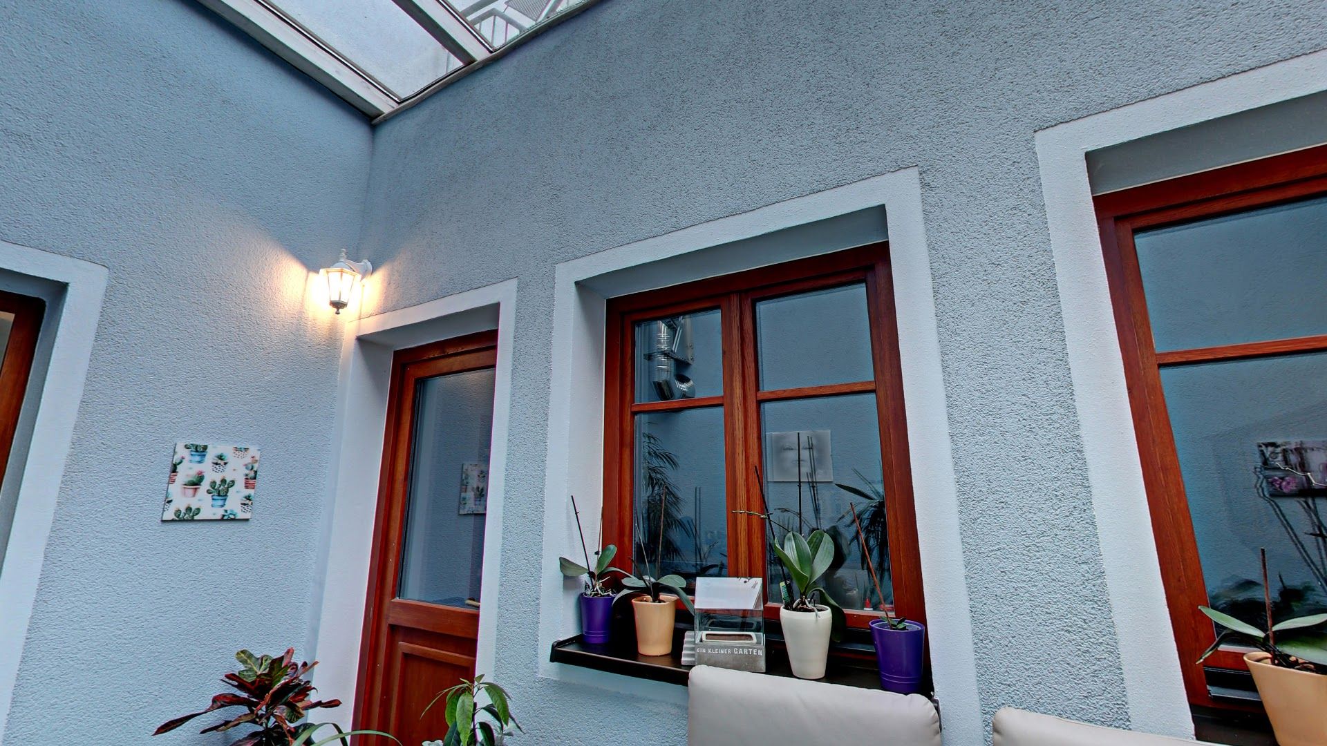 a white couch sitting on a patio next to a window