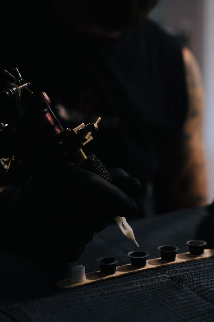 a totenkopf tattoos artist working on a tattoo machine, saale-orla-kreis, germany