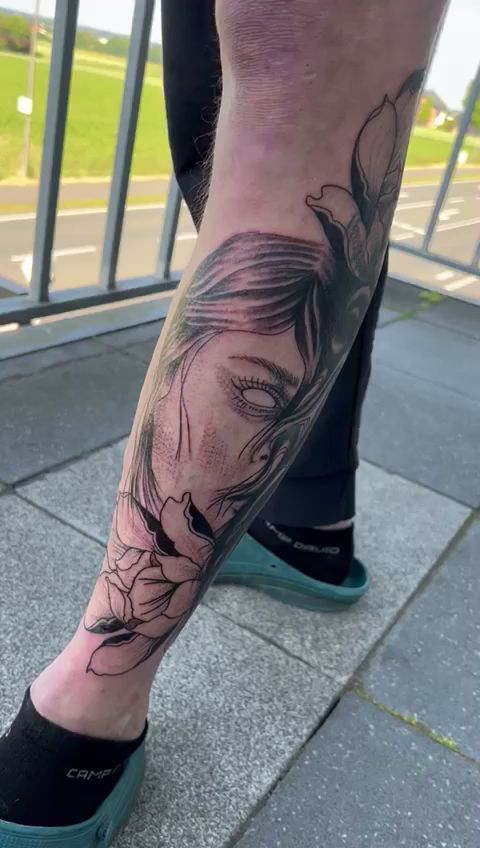 a woman's leg with a cover-up tattoo of a woman's face, minden-lübbecke, germany