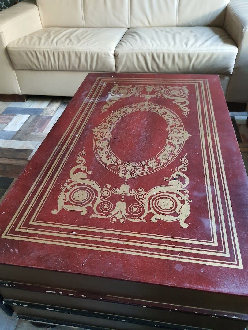 a red table with a gold and white design on it