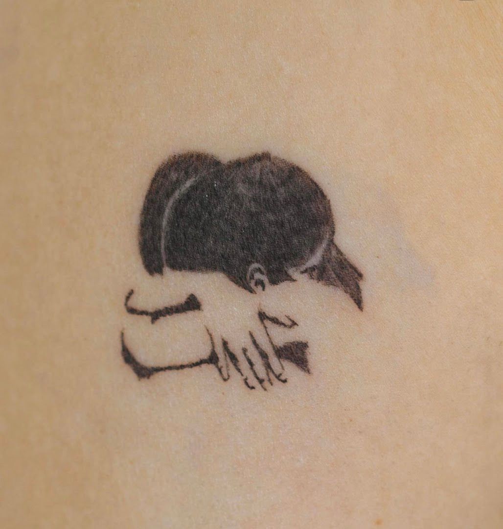 a narben tattoo of a woman's hand with a heart on it, berlin, germany