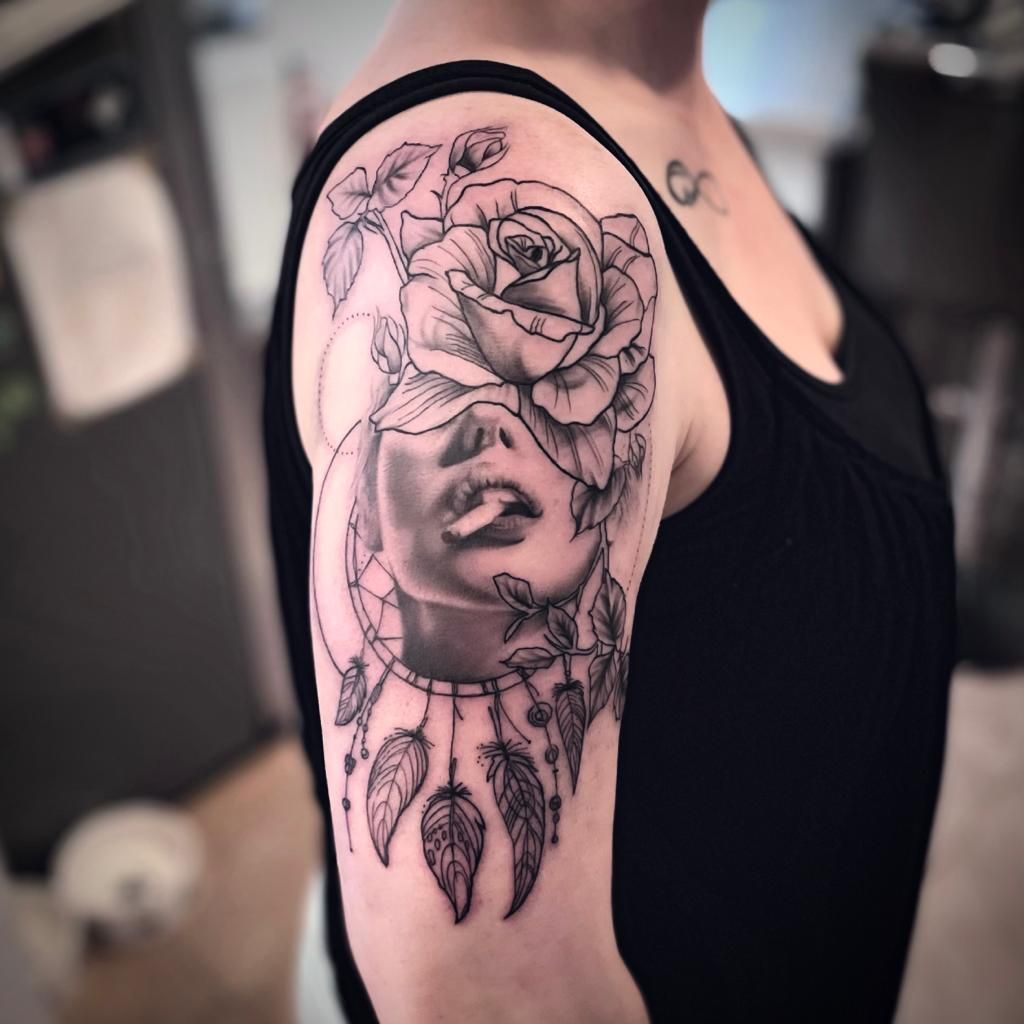 a woman's shoulder with a rose and a rose blackwork tattoo, zollernalbkreis, germany