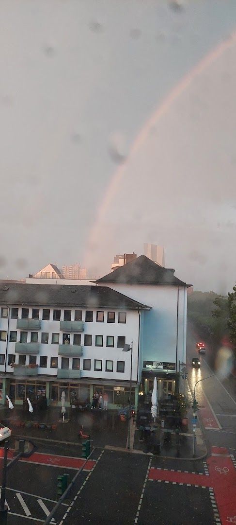 a rainbow appears over a city street