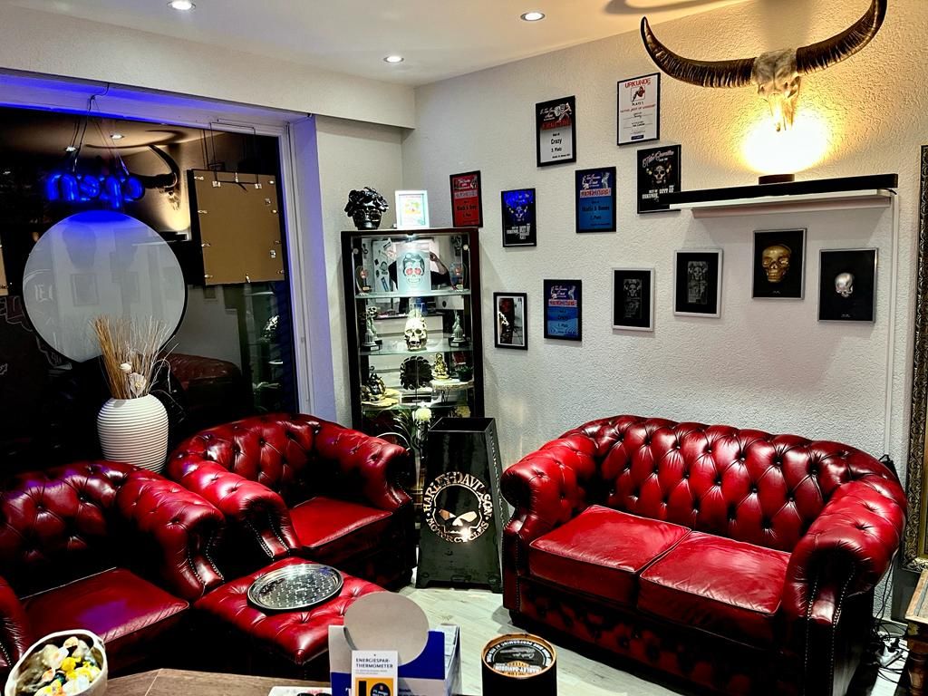 a living room with red leather couches and a table