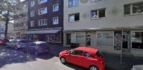 a red car parked in front of a building