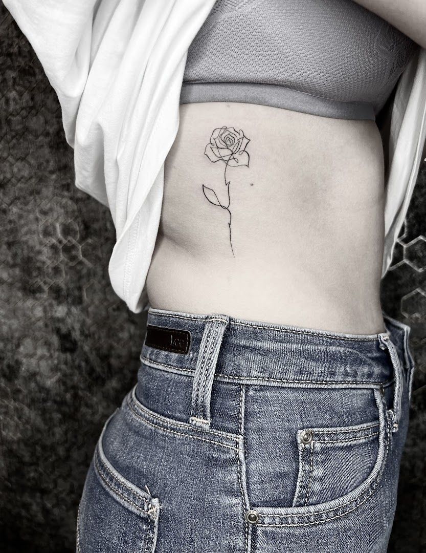 a small rose narben tattoo on the side, düsseldorf, germany