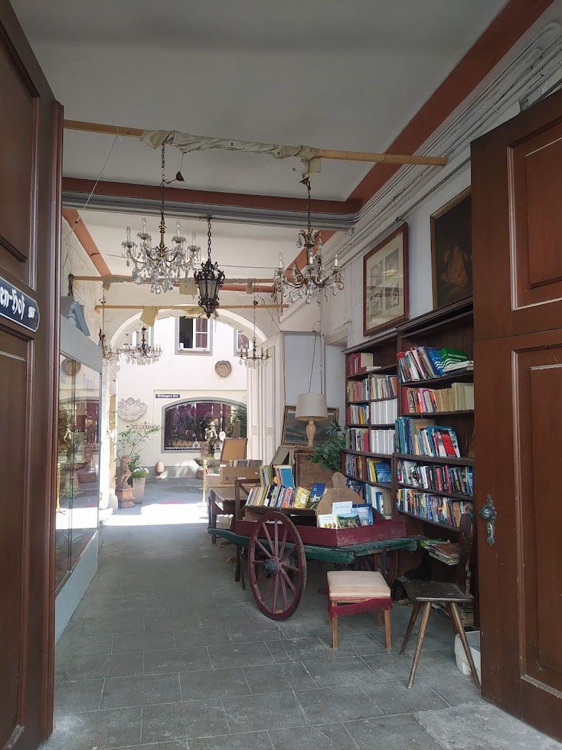 a room with a table and chairs and a book shelf