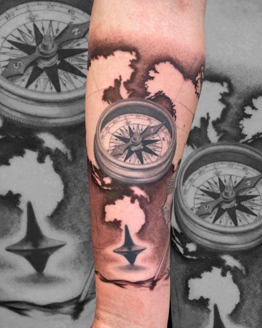 a man's arm with a compass narben tattoo, freising, germany