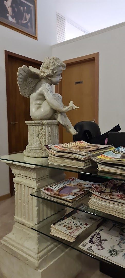 a glass table topped with a statue of a winged angel