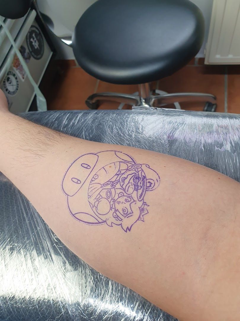 a cover-up tattoo with a purple outline of a skull on the arm, bad kreuznach, germany