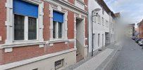 a street with a building and a car