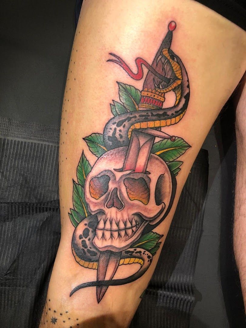 a skull and snake narben tattoo on the leg, mettmann, germany